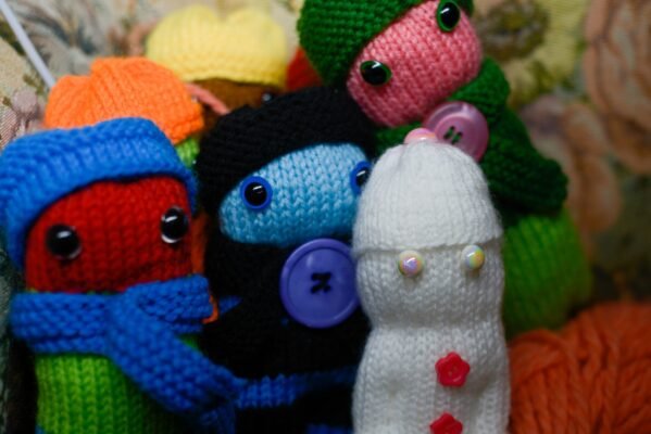 a close up shot of knitted dolls