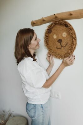woman in holding knitted wall decor